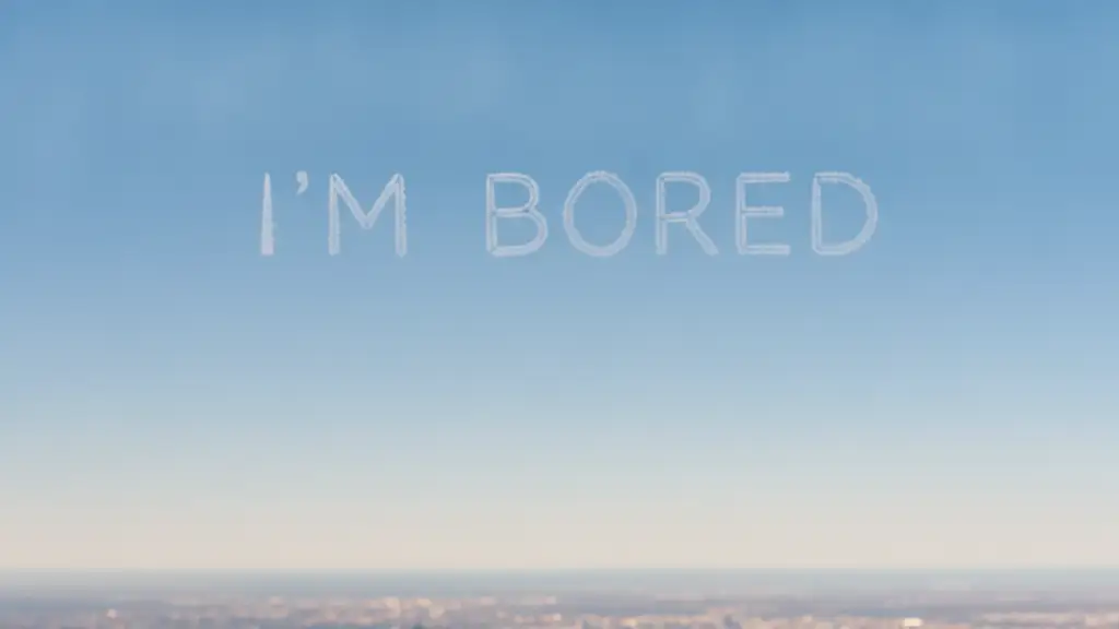 Aerial view of 'I'M BORED' spelled out in white contrails across a blue sky.