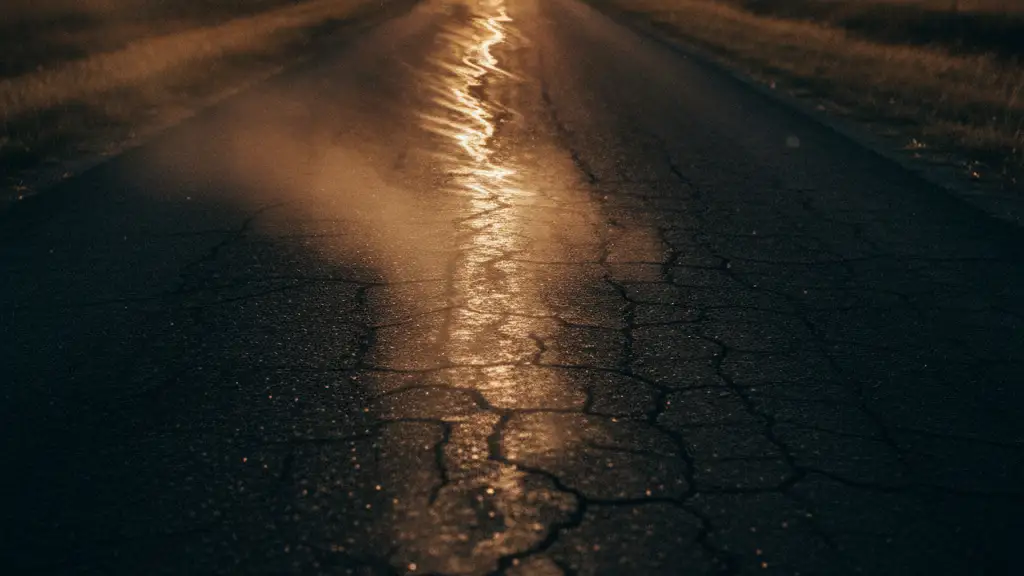 Heat haze rising from a deserted, sun-baked asphalt road in a rural British landscape.
