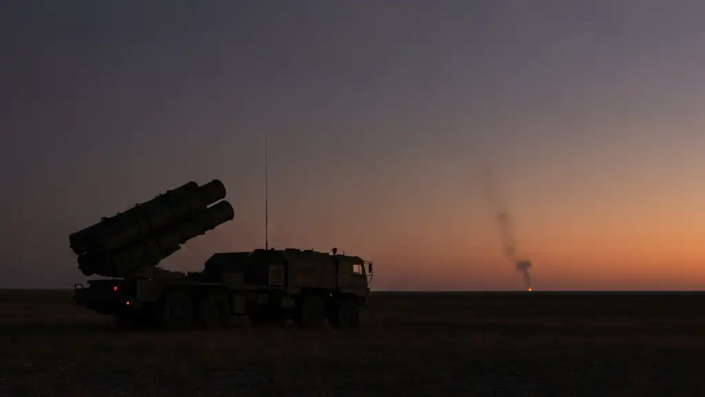 Silhouette of a missile launcher at dusk, faint smoke on the distant horizon.