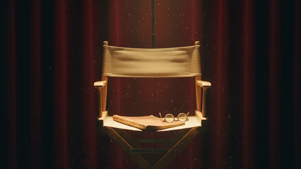 An empty director's chair sits under a single spotlight on a dark stage.