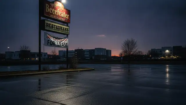 Empty Beefeater restaurant sign with 'CLOSED' banner, dramatic lighting, dusk.