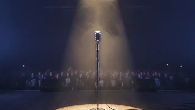 A lone microphone stand on a dark, smoky heavy metal stage under a single spotlight.