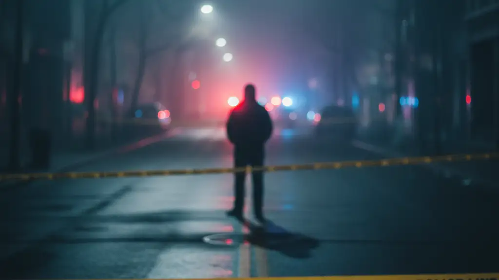 Blurred silhouette of a person against distant emergency lights and police tape.