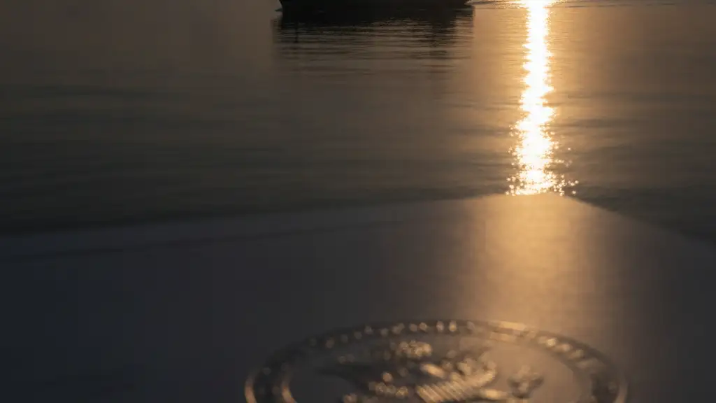 Container ship silhouette on a calm ocean at dawn, diplomatic document corner in foreground.